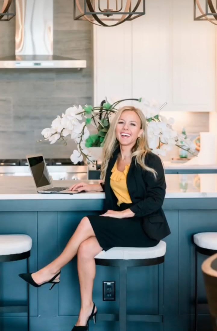 Courtney Willey, REALTOR®, smiling in a modern kitchen